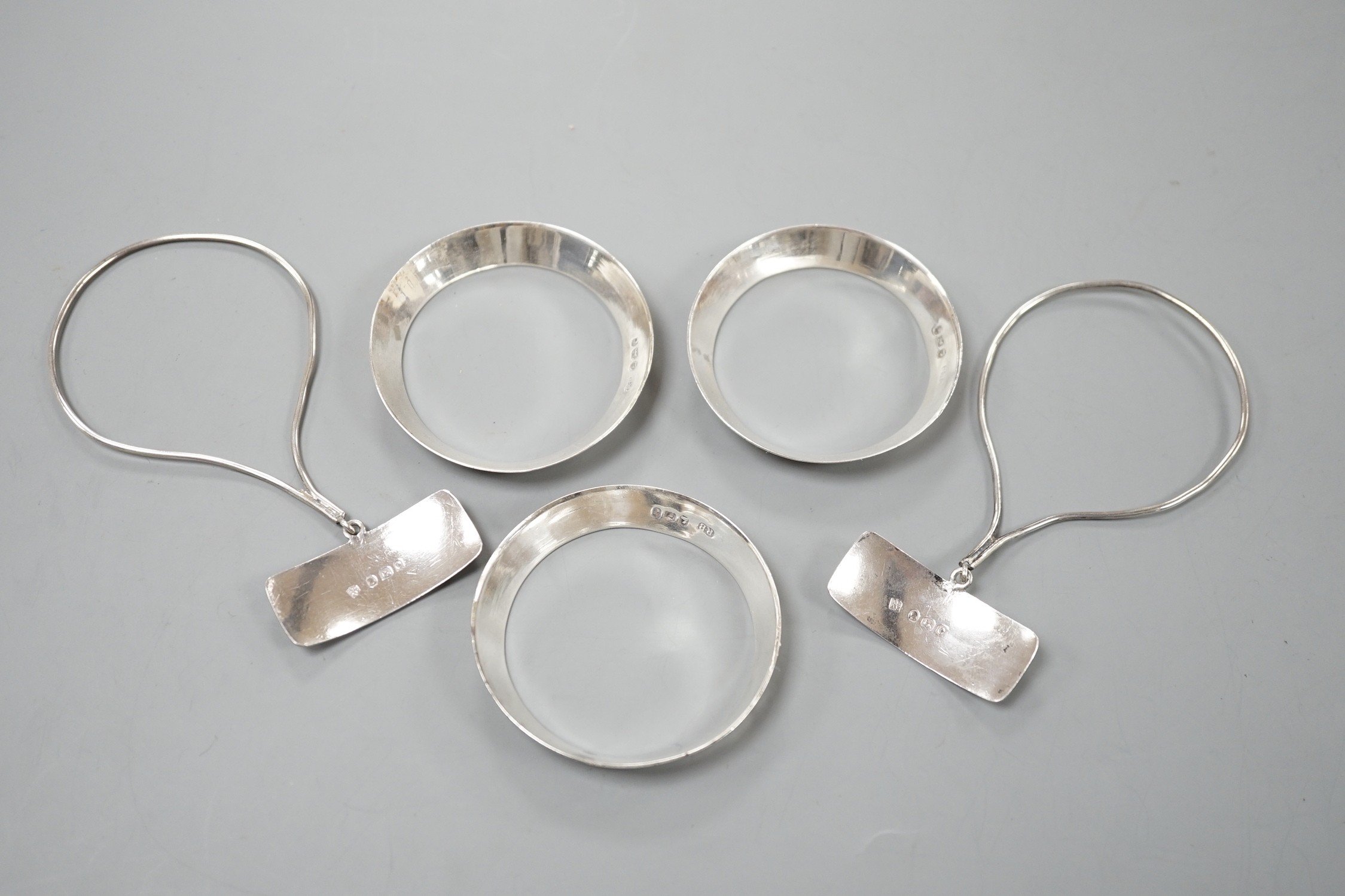 A set of three George silver decanted wine collar labels, Robert Barker, London, 1793 and a pair of similar silver wine label collarettes by Peter & Ann Bateman, London, 1798.